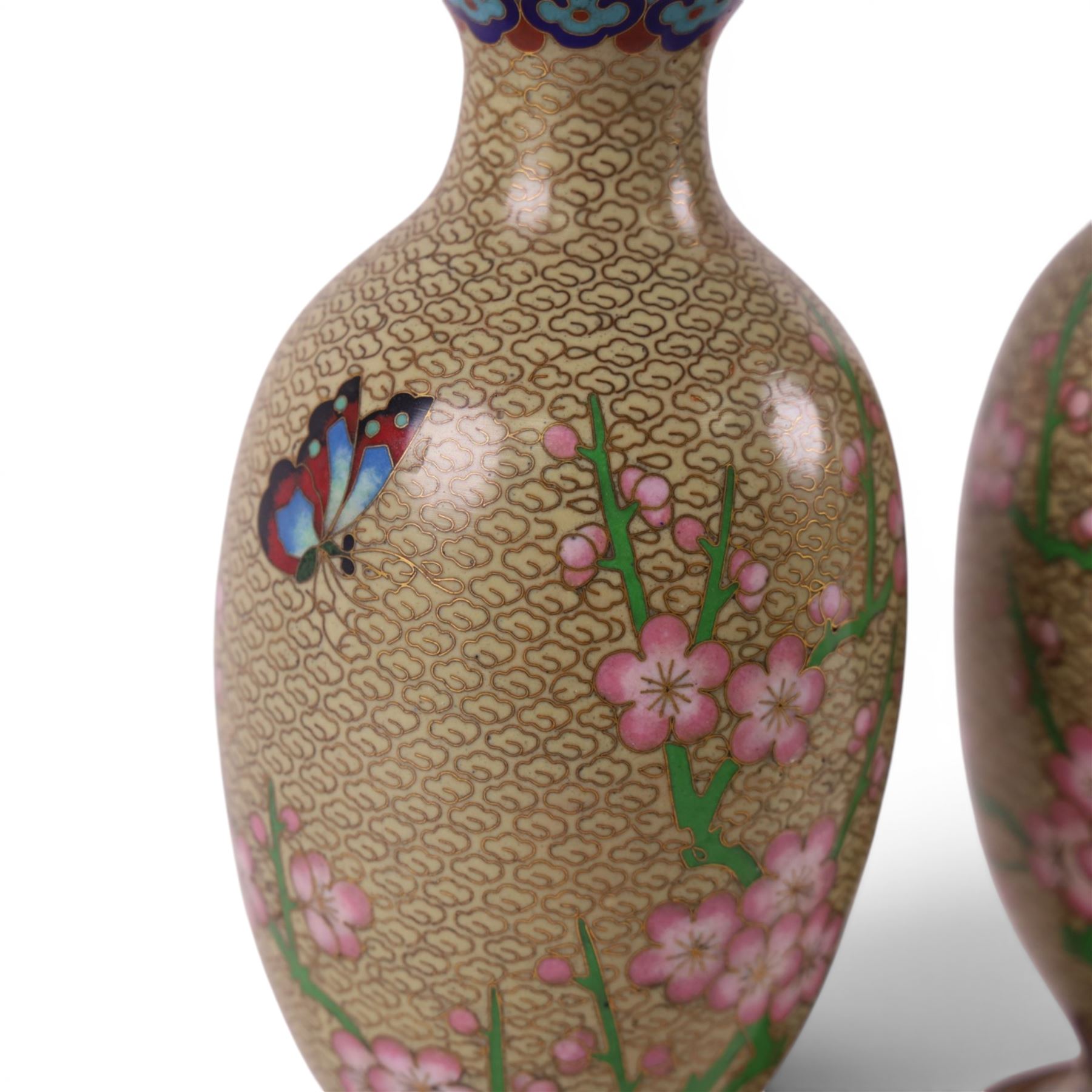 Pair of Cloisonné vases decorated with cherry blossom and peonies, upon a carved hardstone wooden base, H24cm 