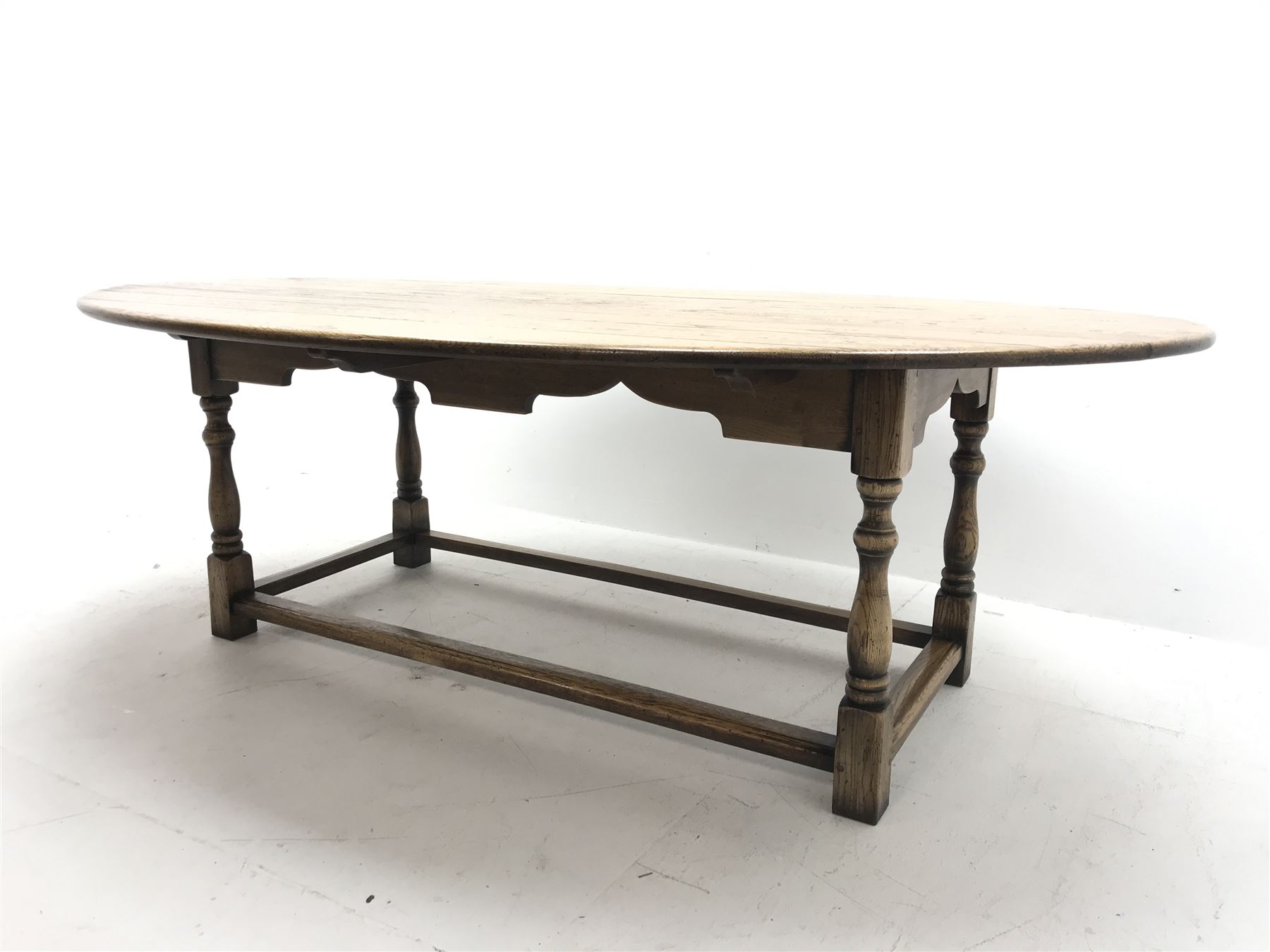 17th century style oval distressed light oak plank top dining table, rectangular stretcher base, L228cm, W150cm, H77cm