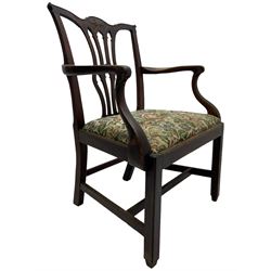 George III mahogany elbow chair, the shaped cresting rail carved with extending foliate motif over Gothic Chippendale design spat, drop-in upholstered seat, shaped arms over moulded seat frame, on square moulded supports joined by plain stretchers 
