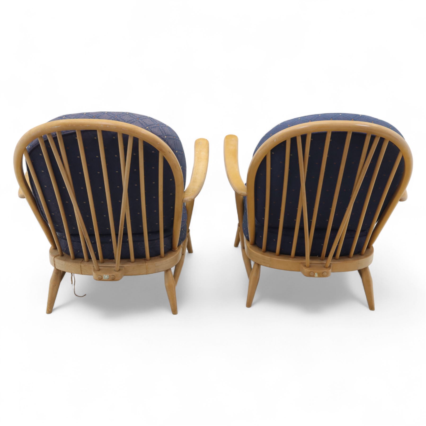 Ercol - Model '203', pair of easy chairs, with blue upholstered cushions and additional orange covers, with looped backrest and shaped spindles, outward swept arms, drop in seat frame