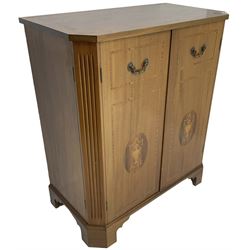 John More of Scarborough -  Edwardian Revival 'Canterbury Cabinet' inlaid mahogany cabinet, fitted with double cupboard decorated with urn motif inlays and banding, flanked by canted fluted uprights, on bracket feet