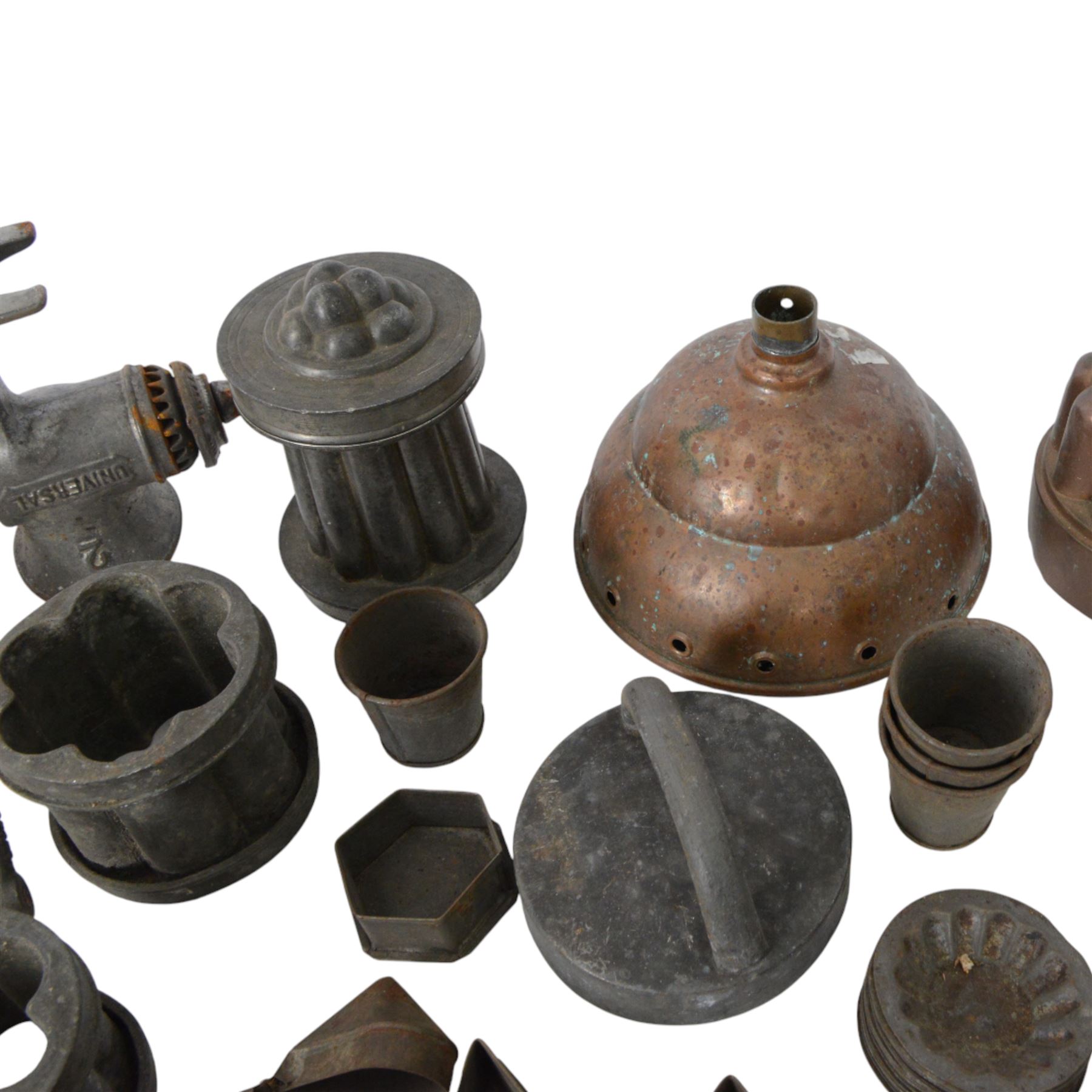 Two copper jelly moulds, collection of metal cookie cutters and moulds, LF&C nut butter grinder, fruit press and other metalware