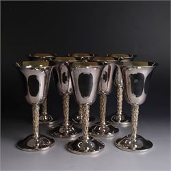 Eight silver goblets, comprising set of six, each plain fluted bowl with gilt interior, upon bark effect stem and domed circular foot, and a pair of very similar examples boxed with large hallmarks to bowls, hallmarked Pinder Brothers, Sheffield 1970 and Sheffield 1976, H14cm