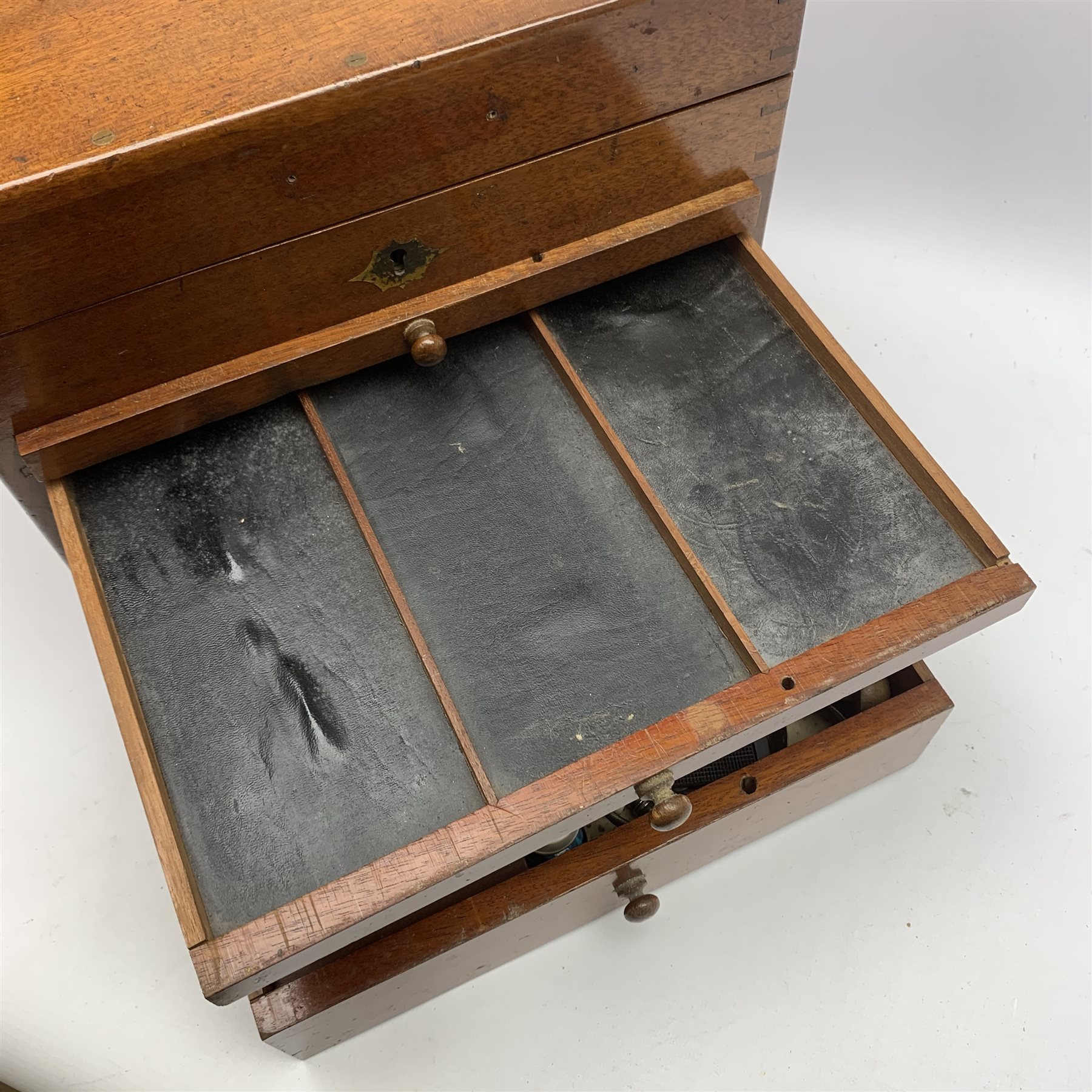  Dentistry - Late Victorian mahogany Dentists cabinet by C. Ash & Co, hinged cover above six long graduated drawers, enclosing a comprehensive arrangement of implements, pharmaceutical bottles, tools, modelling wax, porcelain teeth, 