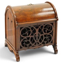 Victorian rosewood enclosed music Canterbury, the domed hinged cover enclosing a three-division interior, above a pierced scrolling foliate fretwork front panel, flanked by curved uprights and raised on scroll feet, hinged top applied with brass registration lozenge for 19 January 1860