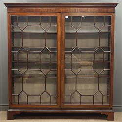  Large Georgian mahogany free standing bookcase, projecting cornice with dentil detail, two astragal glazed doors, eight adjustable shelves, shaped bracket feet, W170cm, H178cm, D44cm  