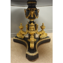  Louis XVl style gilt metal mounted ebonised centre table, the embossed circular top inset with one circular and ten oval Sevres style plaques decorated with Lovers in Garden landscapes, on urn shaped column with rams head and scroll supports, D116cm, H90cm  