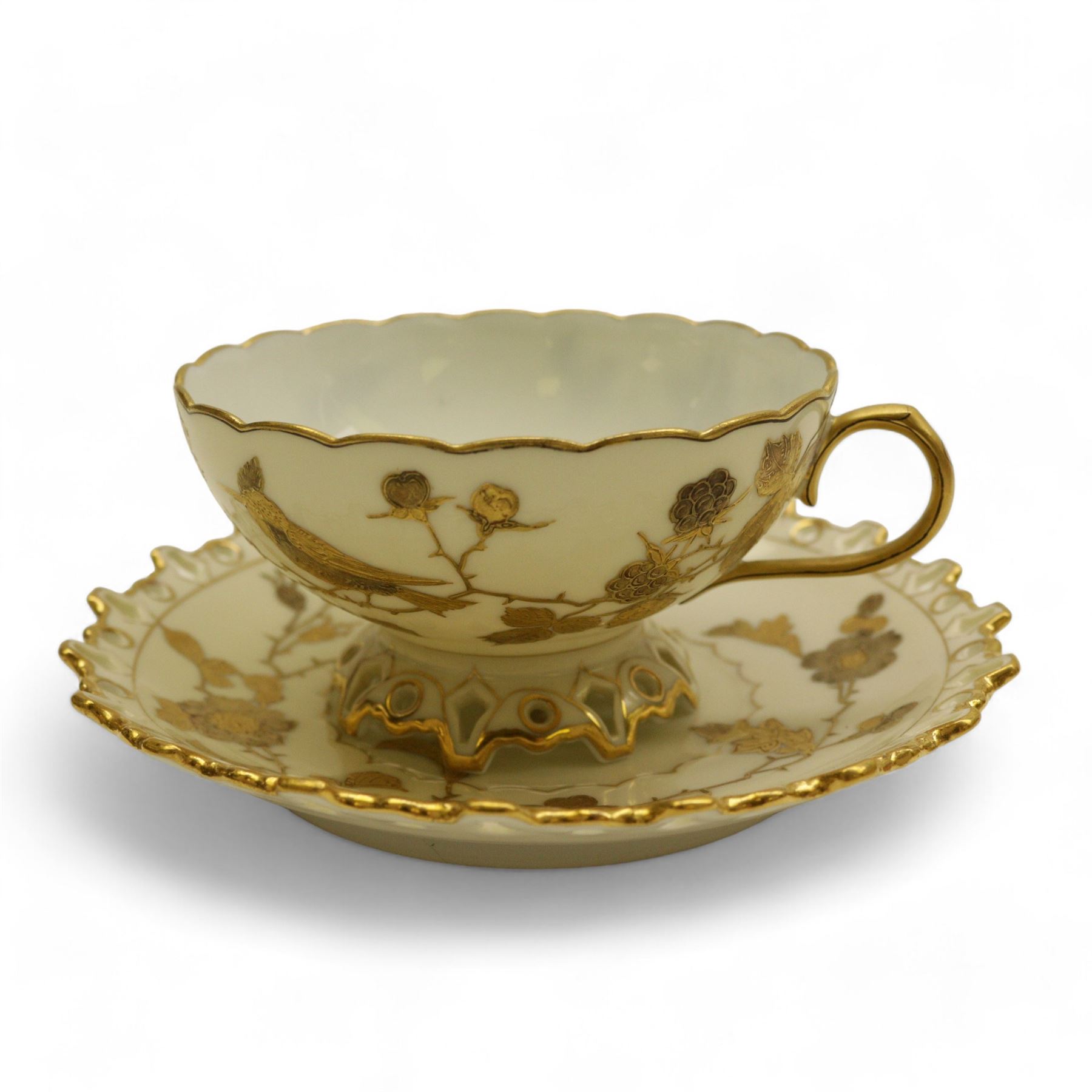 Three Pirkenhammer cups and saucers, two decorated with gilt birds in foliage on an ivory ground, the other with butterflies and foliate sprigs together with three  continental cups and saucers decorated with silver overlay 