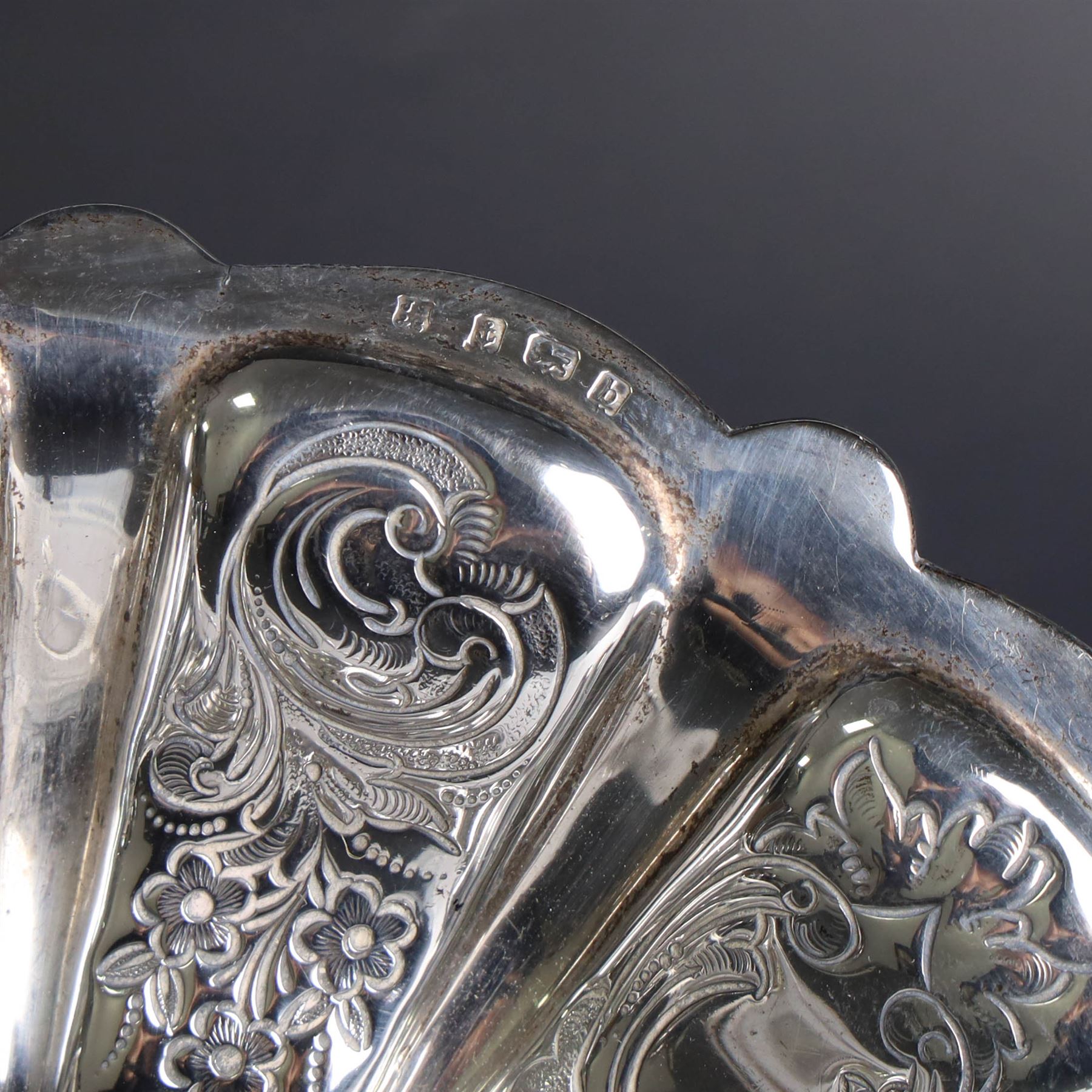 Edwardian silver swing handled basket, of circular form with shaped rim and engraved floral and foliate decoration, with know design swing handle and upon circular stepped pedestal, hallmarked J Sherwood & Sons, Birmingham 1901, H9cm, D22cm