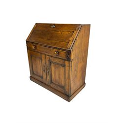 19th century waxed pine bureau, the fall front opening to reveal fitted interior with two drawers and five pigeonholes, base with single drawer over two panelled cupboard doors, on plinth base