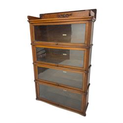 Mid-20th century oak 'Globe Wernicke' library stacking bookcase, four sections each with hinged and sliding glazed doors, shaped fronts with reeded uprights 