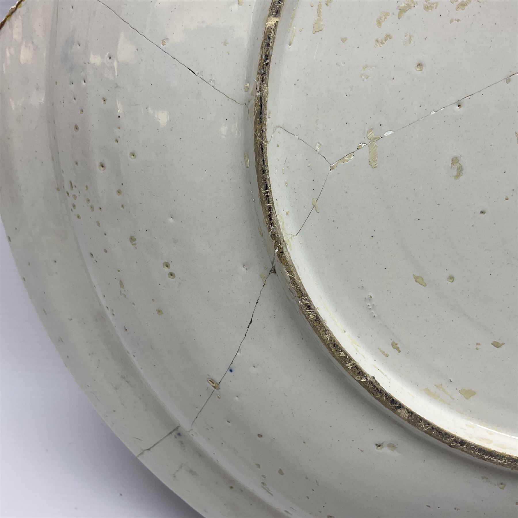 Early 18th century Delft marriage plate, of circular form with dished centre, the centre inscribed and dated 'Thomas and Elizabeth Kockerill Bridlington Key 1715' within a crowned C scroll cartouche, flanked by demi-griffins, above a putto head and tassels, within a wide foliate border, D34cm
