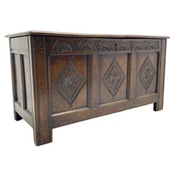 18th century oak coffer or chest, rectangular triple panelled hinged top with moulded edge enclosing main compartment and candle box, the frieze carved with repeating concentric lunettes and foliate patterns, the front fielded panels decorated with lozenges containing central flower heads, on stile supports