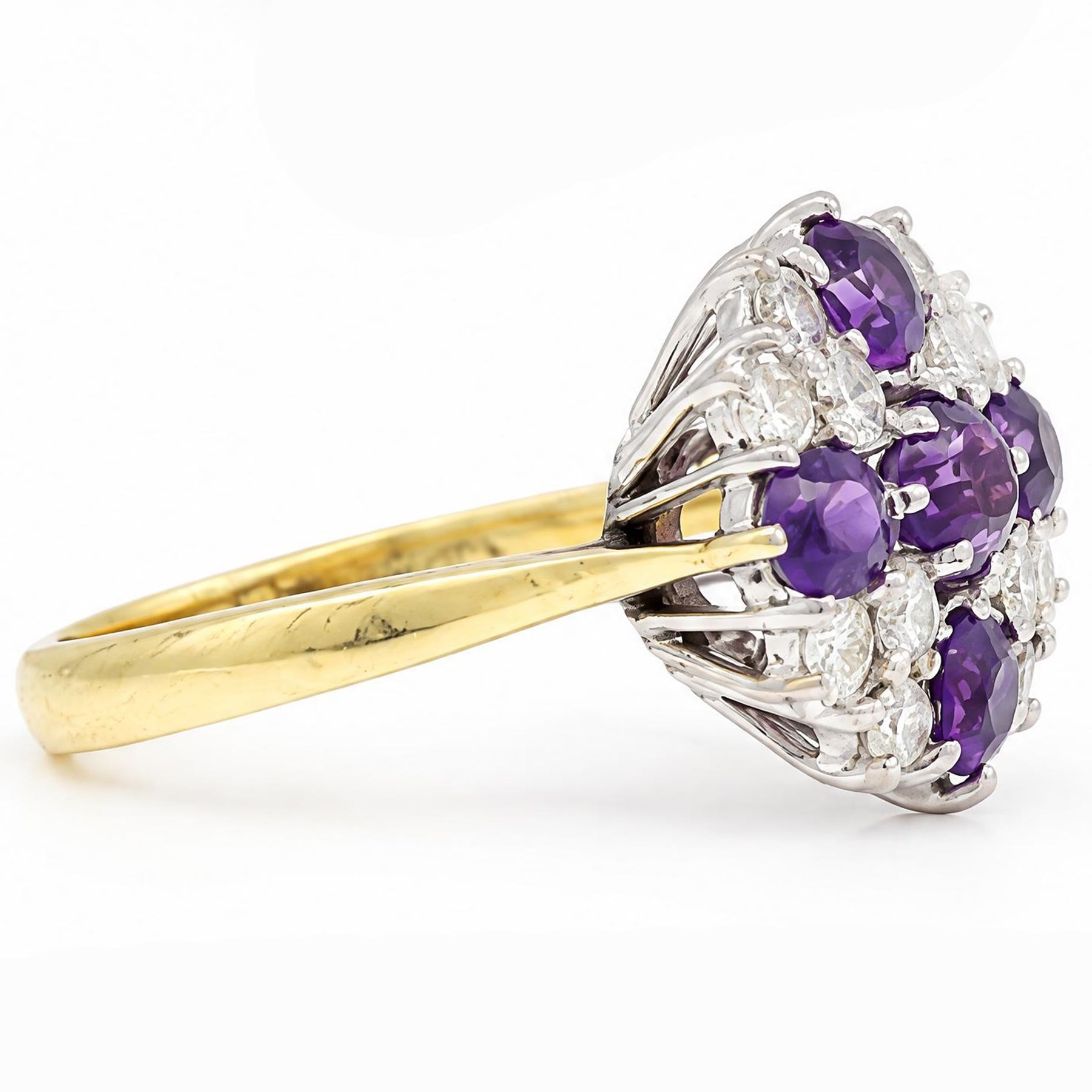 18ct gold amethyst and diamond cluster ring, five round cut amethysts, spaced by twelve round brilliant cut diamonds, London 1979, total diamonds 0.67 carat