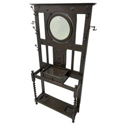 Edwardian oak hallstand, projecting moulded cornice over circular bevelled swing mirror, decorated with split beading and geometric mounts, fitted with single drawer and two stick or umbrella stands with drip trays, on spiral turned supports