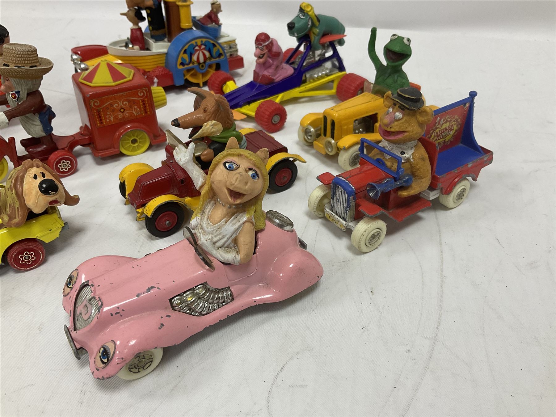 Corgi/Dinky - twelve unboxed and playworn TV/Film related die-cast models including Popeye Paddle Wagon; Dick Dastardly; Magic Roundabout; Muppets; Basil Brush; and Noddy (12)