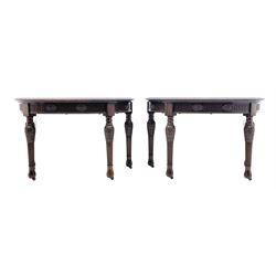 Pair early 20th century Hepplewhite style mahogany D-end console tables, the curved top with foliate carved edge, fluted frieze rails carved with flower heads, turned and reeded acanthus supports with recessed castors