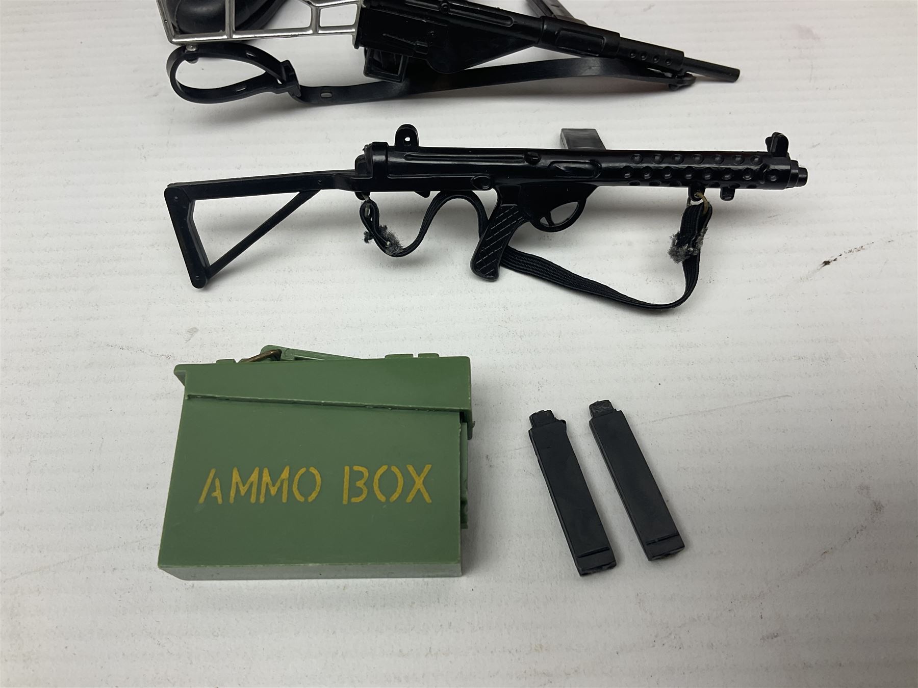 Palitoy Action Man Action Soldier No.34014 with tunic, belt, trousers, boots, blue beret and sten gun; in original box; and Palitoy Action Man Royal Military Policeman (RMP) gripping hands figure, marked 'Made in England by Palitoy under licence from Hasbro © 1964' to rear of torso; with tunic, shirt, trousers, tie, boots, belt, truncheon, pistol in holster, MP armband, red cap, Sterling machine gun and other clothing etc; in anrelated display box (2)