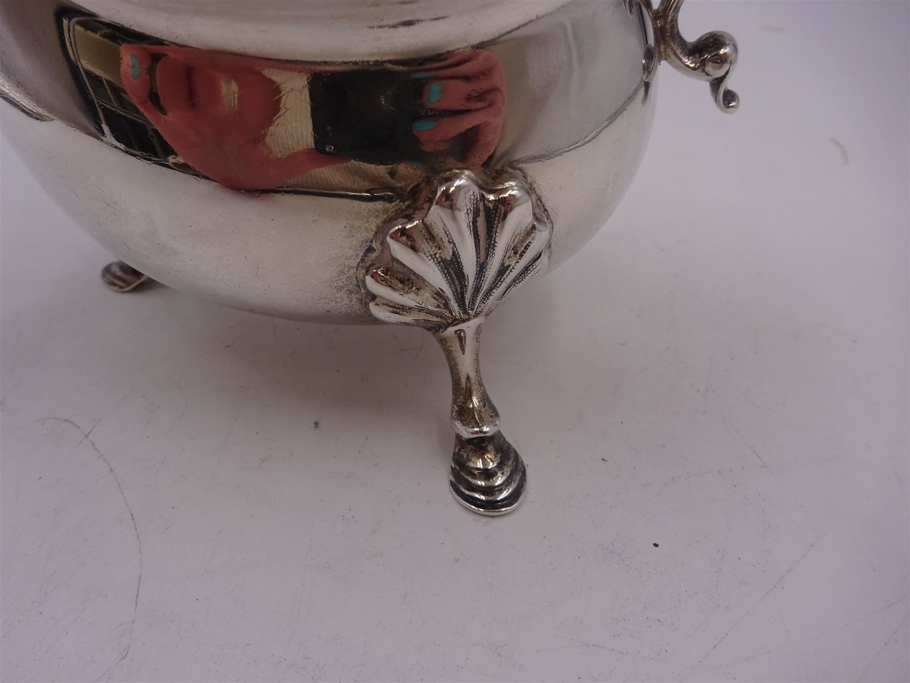 Victorian silver sauce boat, of typical plain form, with shaped rim and acanthus capped flying scroll handle, upon three hoof feet, hallmarked Walker and Hall, Sheffield 1899, including handle H12cm