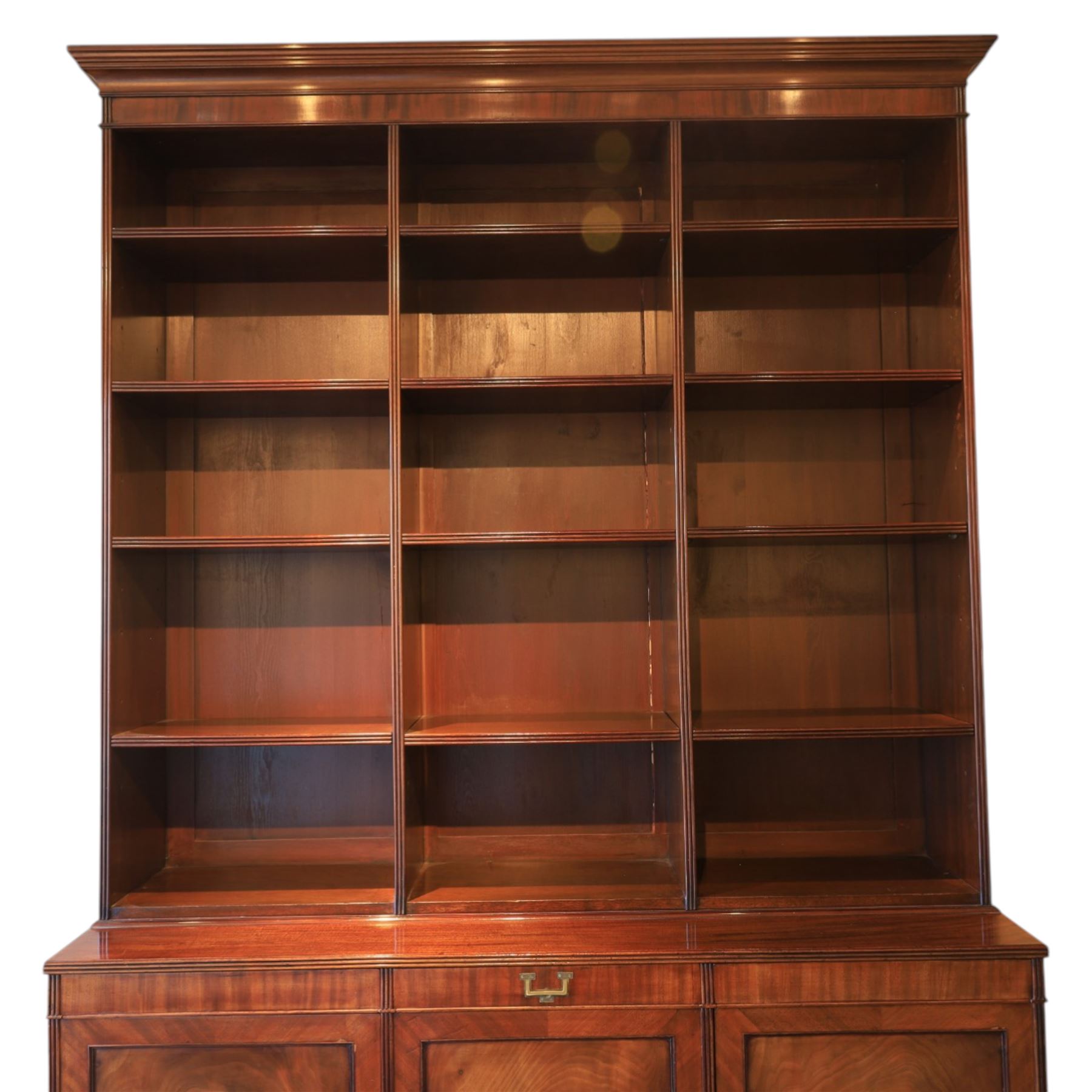 Early 20th century mahogany open bookcase, with reeded upright divisions and adjustable shelves, over a cupboard base fitted with three frieze drawers and three panelled doors, on plinth base