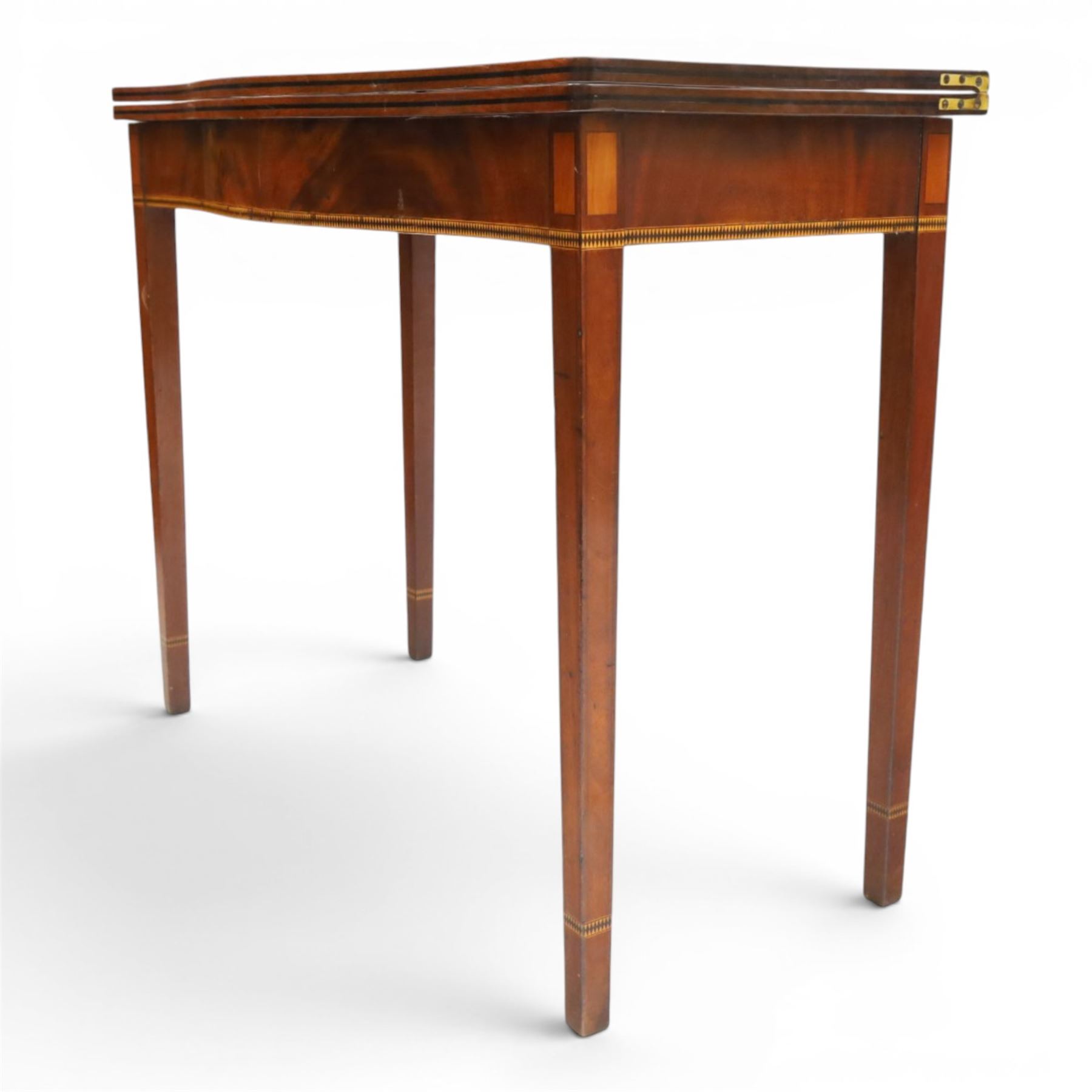 Regency period inlaid mahogany serpentine-fronted fold-over tea table, the shaped rectangular top with ebony-strung edge over a banded frieze with repeating lozenge inlaid banding, on square tapering supports