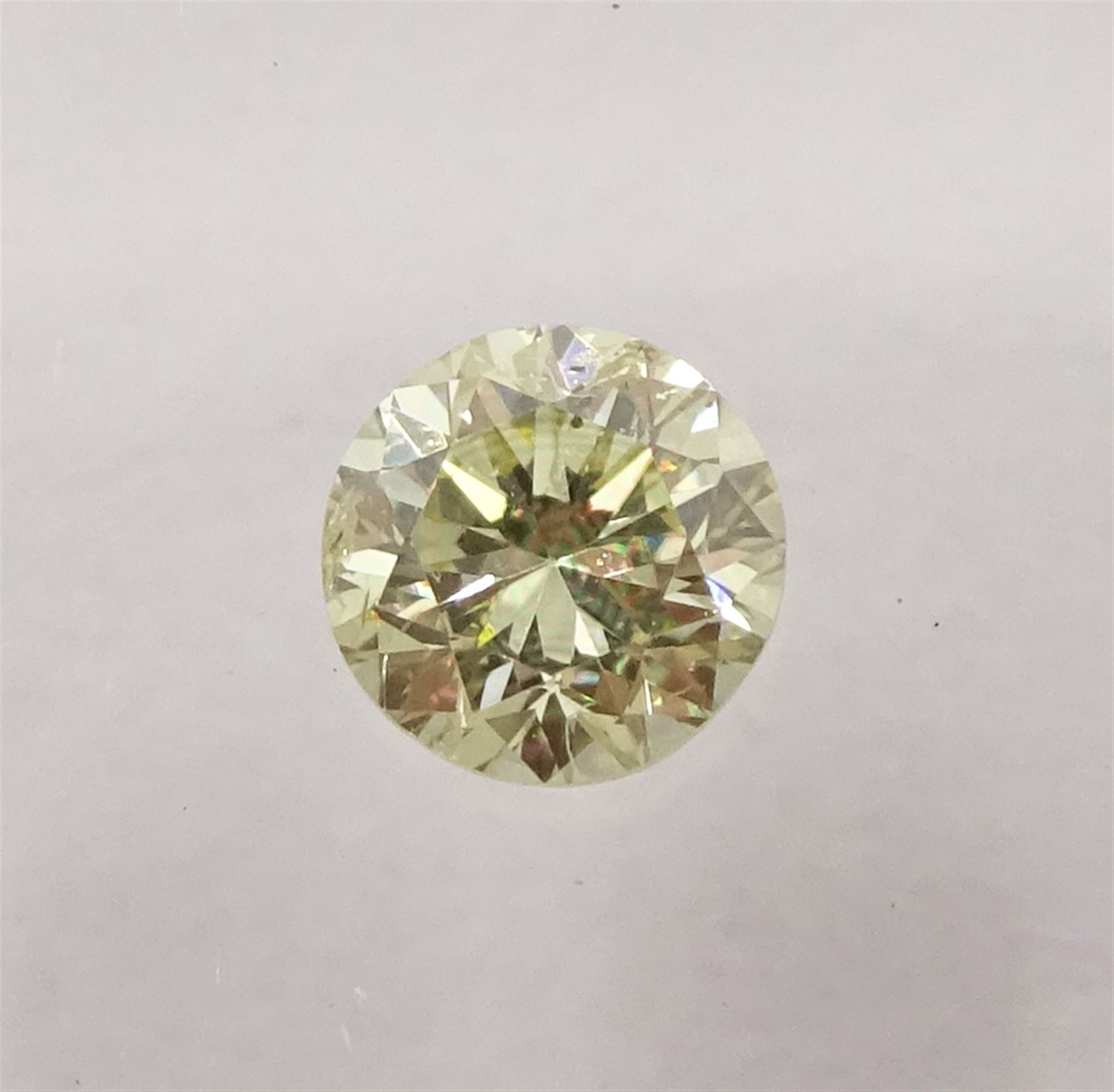 Two certified loose fancy coloured diamonds one round brilliant cut 'fancy light yellow' of 0.13 carat, the other cushion cut 'fancy intense brownish yellow' colour of 0.11 carat, with International Gemological Institute Certificates