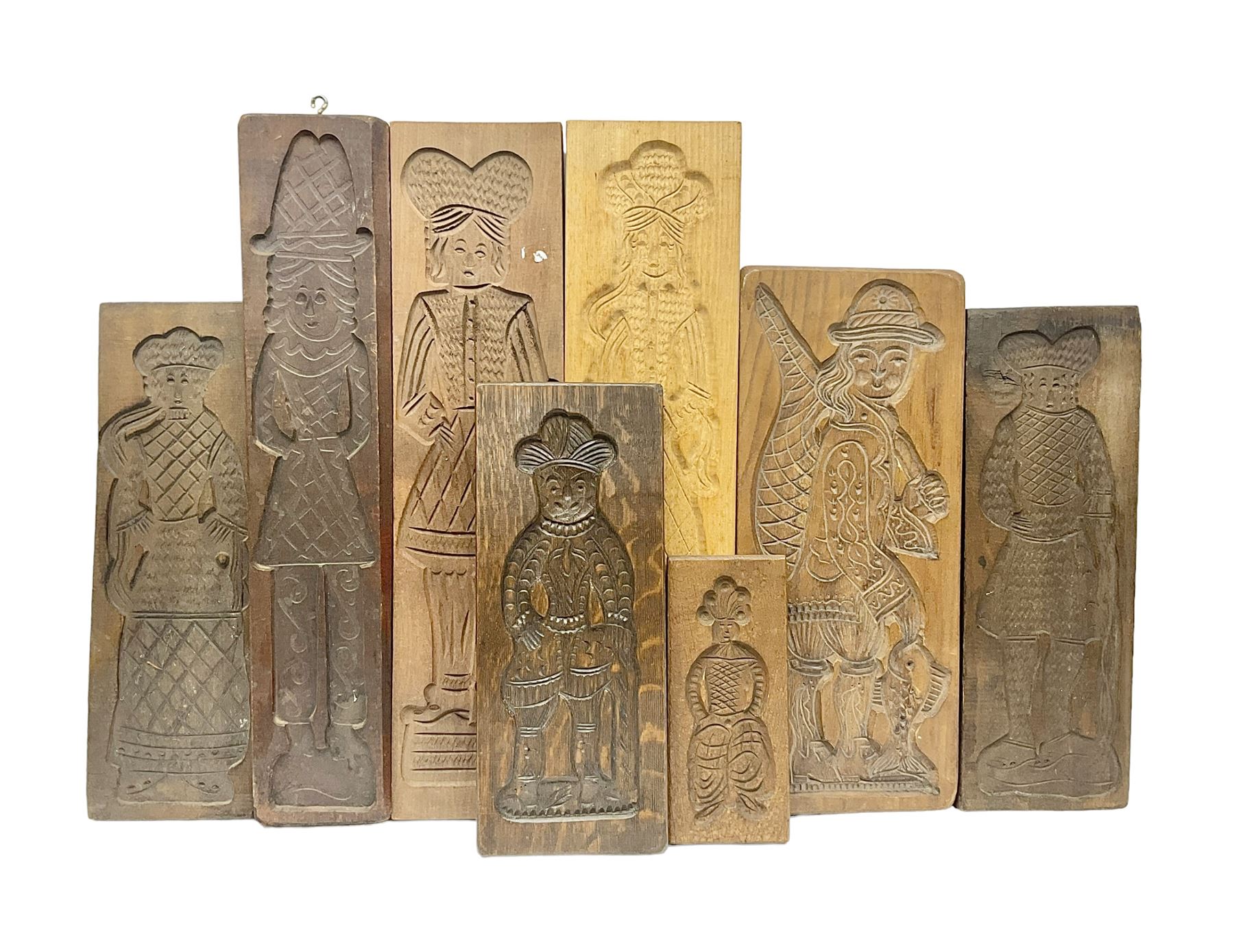 Eight 20th century hardwood Dutch folk art Speculaasplank or biscuit moulds, most examples typically carved with figures in traditional dress, tallest H60cm