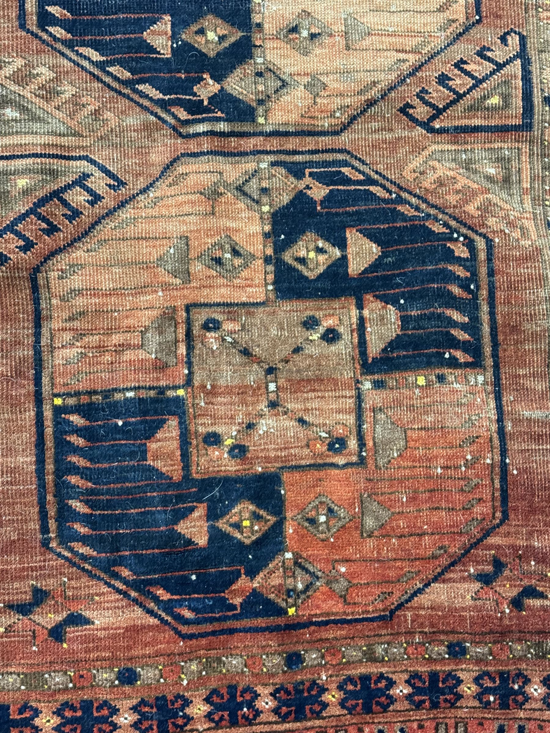 Turkish Kilim ground rug, the field with alternating horizontal bands of geometric patterns, bordered by repeating diamond motifs (145cm x 242cm); Turkish red ground rug, the field with three octagonal medallions (113cm x 172cm) (2)