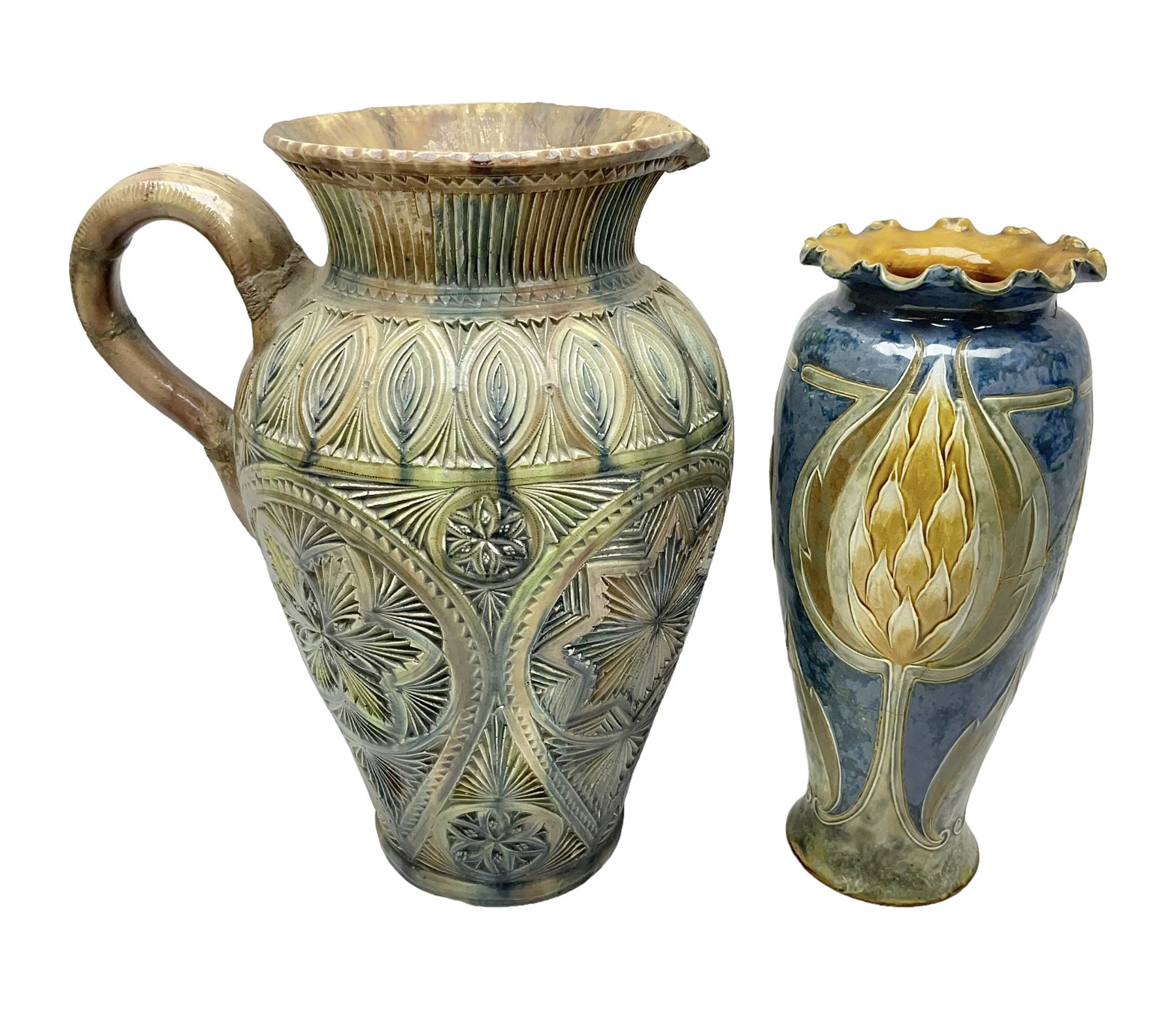 Early 20th century Royal Doulton stoneware vase, decorated with a stylized floral design below a wavy rim, monogrammed B.N, possibly for Bessie Newbery, H28cm, together with an early 20th century glazed jug, heavily carved throughout (2)