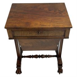 William IV figured mahogany work or sewing table, rectangular top over a single frieze drawer and sliding well, tapered end supports on rectangular platforms joined by turned stretcher, foliate carved paw feet with scroll and lobe carved tops, brass castors