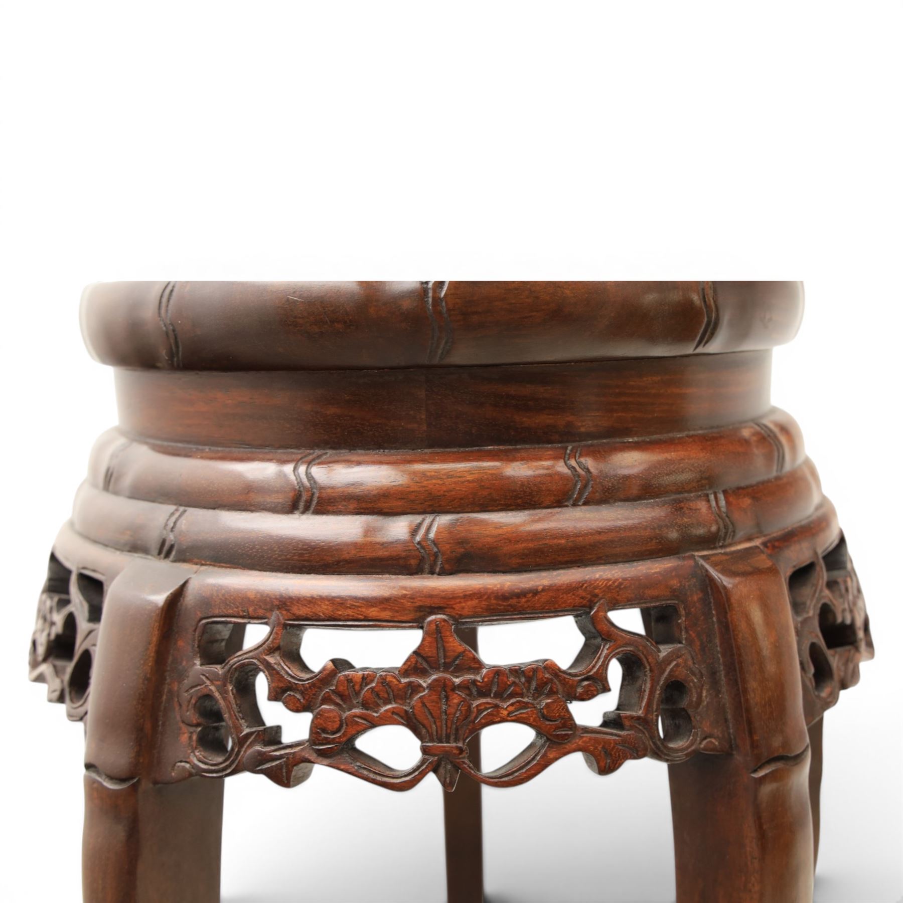 Chinese hardwood jardiniere stand, with inset black veined white marble, pierced carved apron united by rose carved undertier