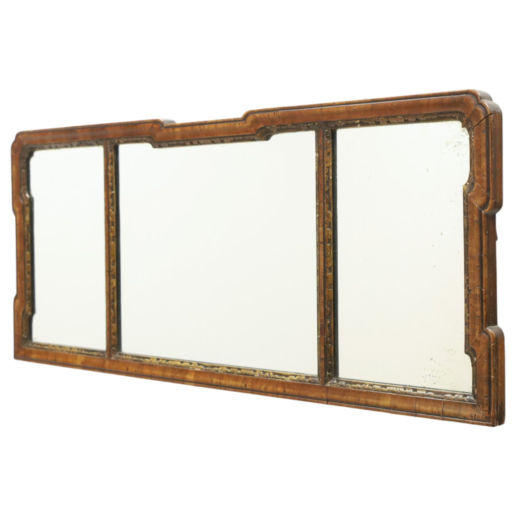 George III tripartite walnut overmantel mirror, shaped moulded frame with foliate carved gilded inner slip, enclosing an original mercury mirror plate, later applied back 