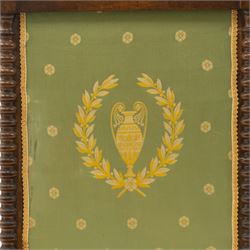 Victorian mahogany firescreen, the rectangular upholstered panel decorated with a Greek urn within laurel wreath on green ground, within spiral turned uprights, on downswept supports united by a turned stretcher