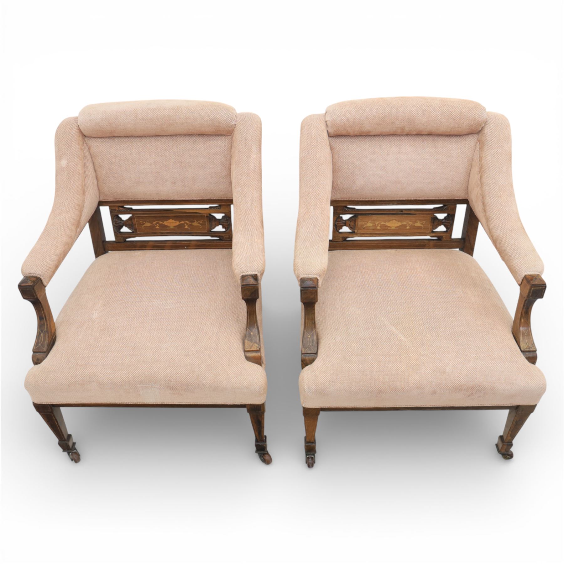 Quality Edwardian seven piece inlaid salon suite, comprising three seater settee, pair of arm chairs and four chairs with pierced splat backs, upholstered in pale pink fabric, inlaid with flowering urns, upon tapering legs with spade feet and castors