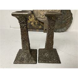 Pair of bronzed oriental column candlesticks, embossed with floral decoration throughout, together with a similar pedestal bowl, decorated with irises, a Japanese mirror, three Oriental embossed trays and a copper box embossed with an eagle to cover, candlesticks H19.5cm