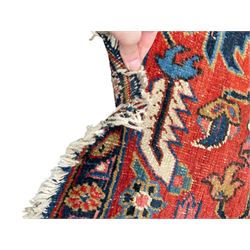 Persian blue ground carpet, the field divided up into panels by trailing bands with flower heads, each panel decorated with palmettes and stylised plant motifs, the border decorated with further palmettes, within floral pattern guard stripes 
