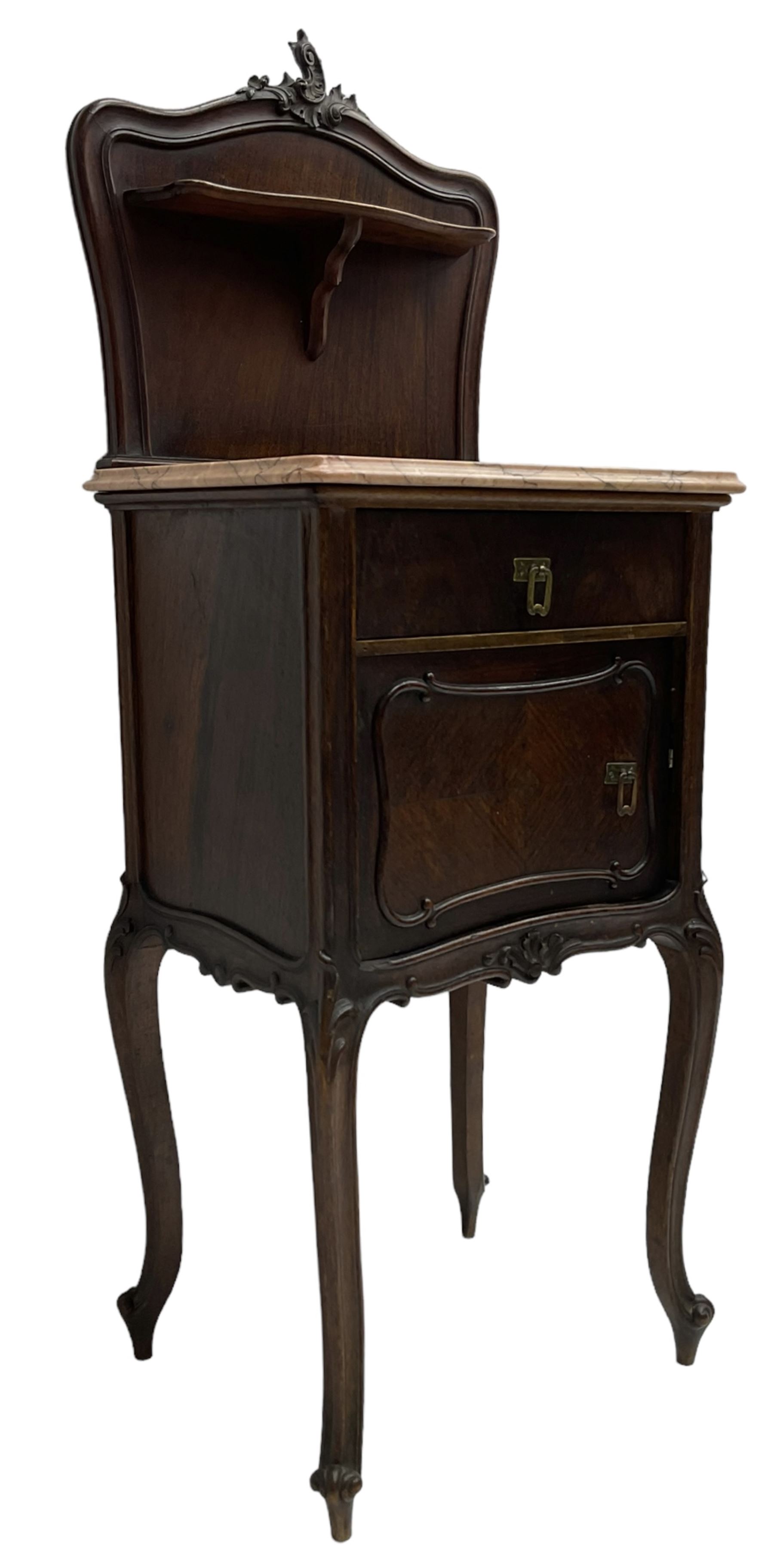 Late 19th to early 20th century walnut bedside pot cupboard, the shaped raised back with carved C-scroll pediment, pink variegated marble top, fitted with single drawer and cupboard, foliage carved cabriole supports with scroll carved terminals