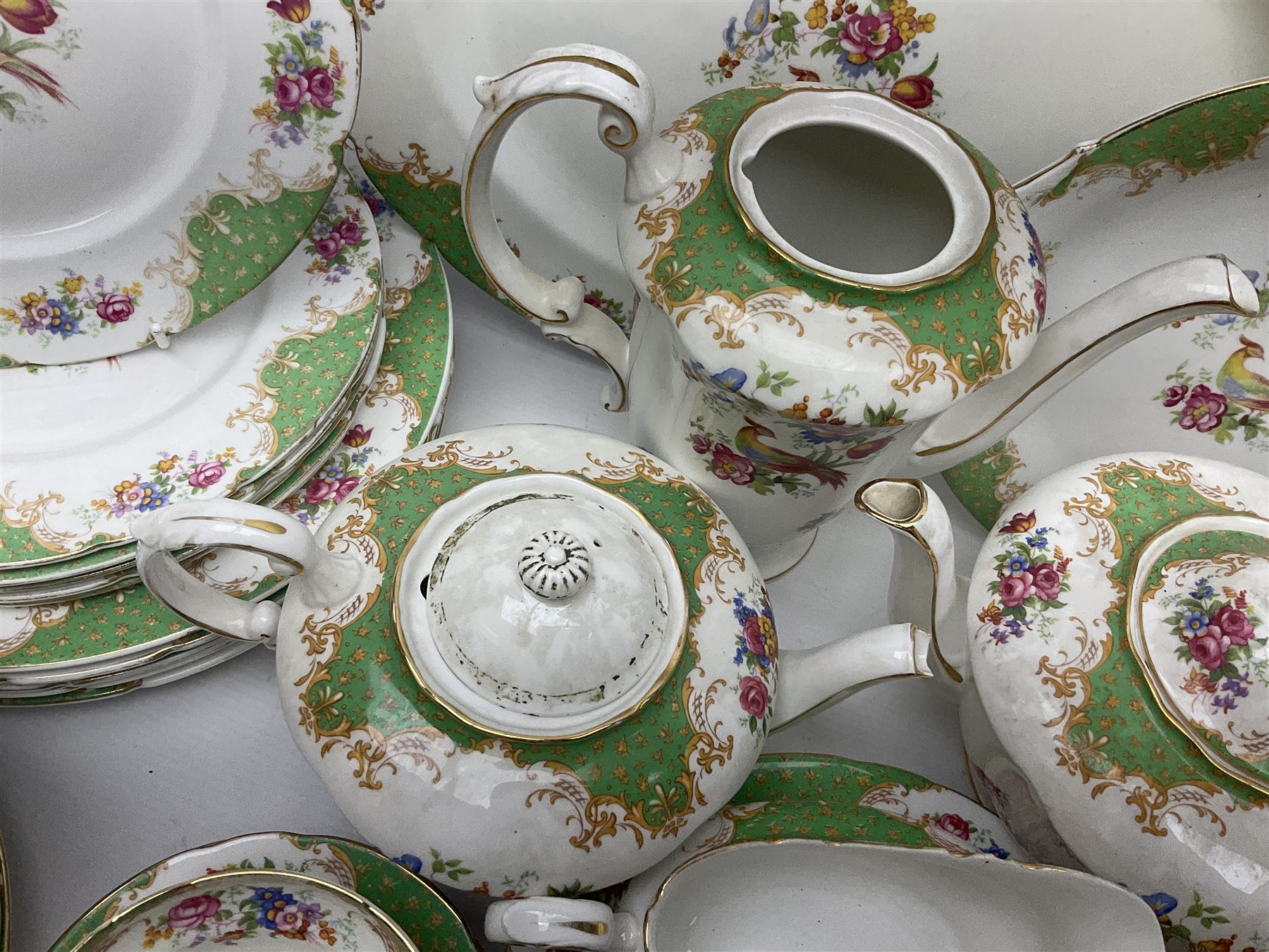 Paragon Rockingham pattern part tea and dinner service including three teapots, milk jug, cups and saucers of various sizes, ten soup bowls, ten side plates, ten dinner plates etc (96)
