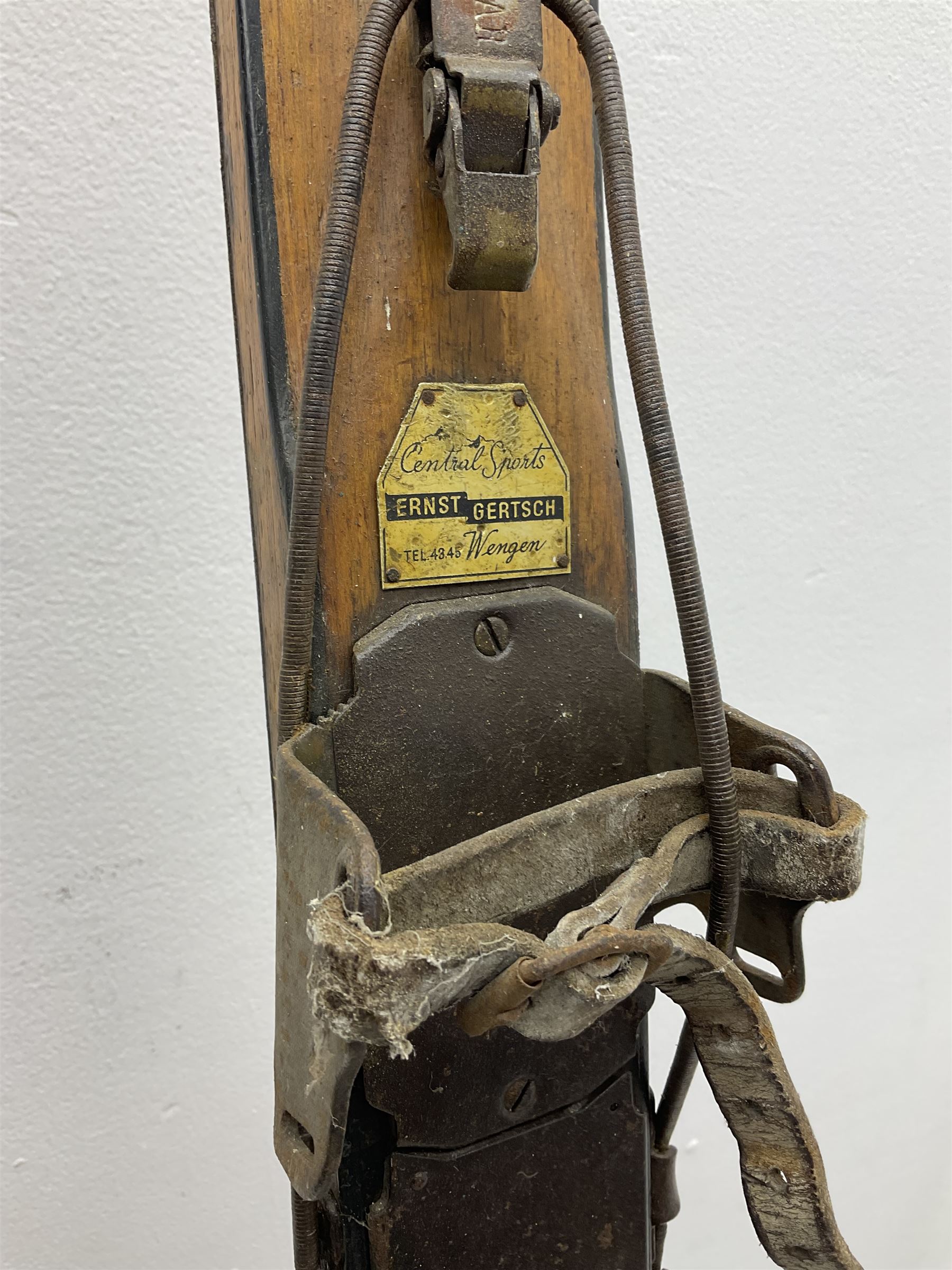 Pair of 1930s wooden skis, with painted metal runners beneath stamped Attenhofer, with retailers label for Ernst Gertsch Central Sports, L206cm