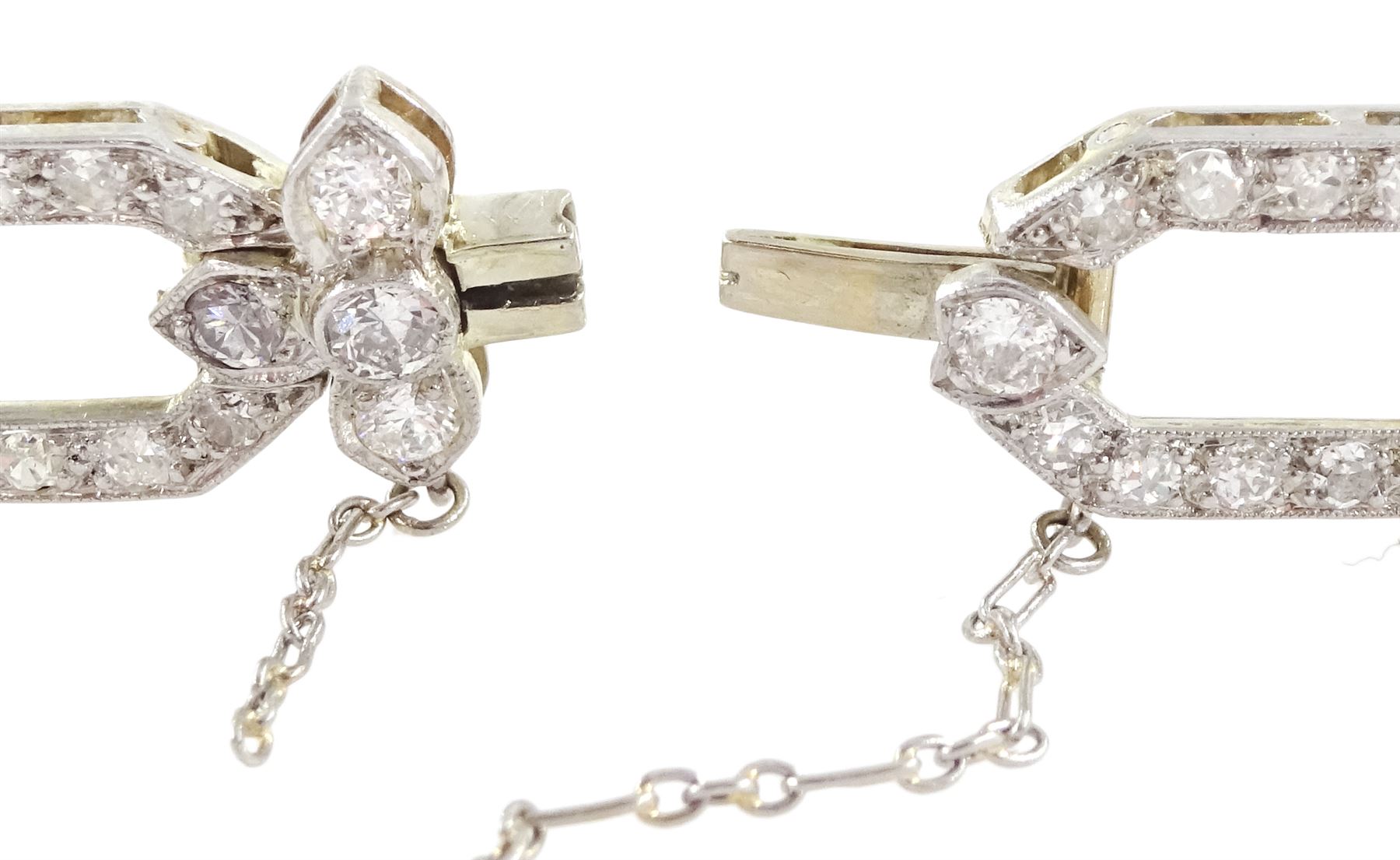 18ct white gold and platinum, milgrain set old cut diamond flower head and openwork panel link bracelet, total diamond weight approx 4.25 carat