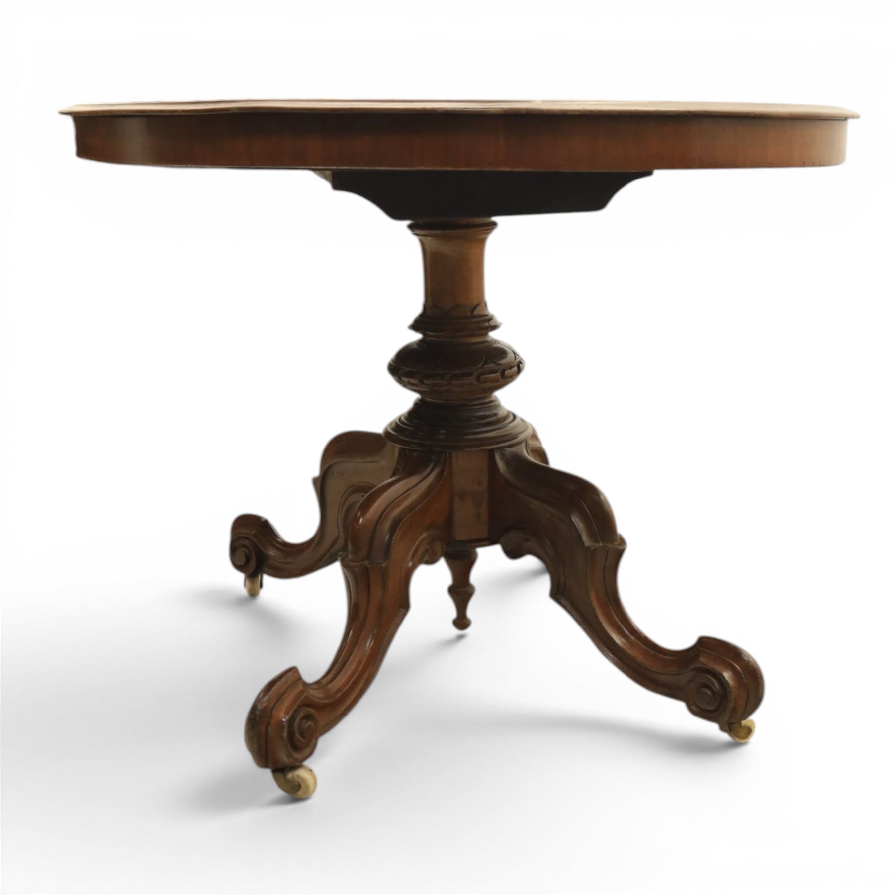 Victorian mahogany oval centre table, raised on turned column with four carved legs, ceramic castors