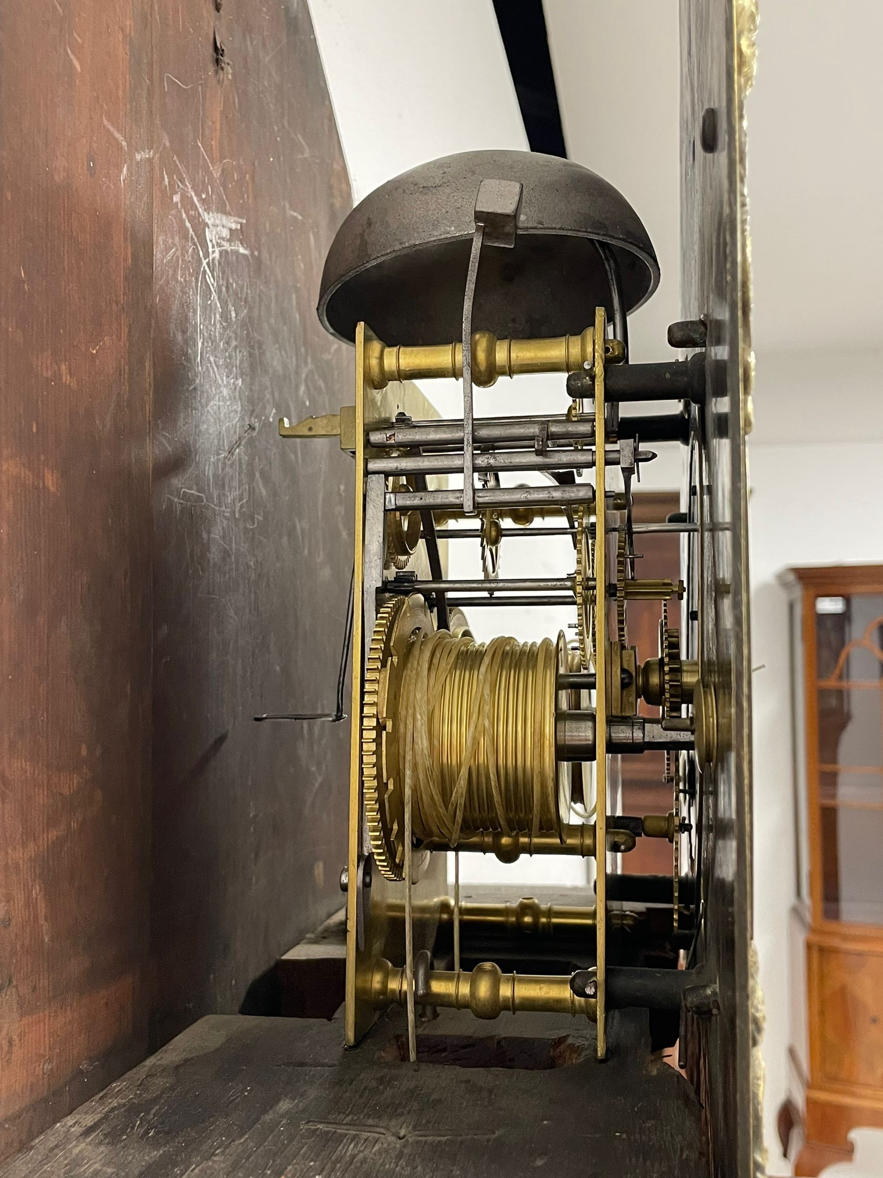 18th-century profusely carved oak longcase clock - with a pagoda pediment, upstands and carving, 
 break arch hood door flanked by reeded pilasters with brass capitals, trunk with canted corners and a spire topped door, square plinth with applied skirting, break arch brass dial with wheatsheaf engraving and cast cherub and crown spandrels, engraved break arch with the London clockmakers name John Gordin, silvered chapter ring with Roman numerals, five minute Arabic's, minute and quarter hour tracks, matted dial centre with ringed winding holes, square date aperture and seconds ring, dial pinned to a five pillar movement with inside countwheel striking, striking the hours on a cast bell. With weights and pendulum. John Gordin, is possibly a mis-spelling or phonetic spelling of John Gordon, of London, who worked from Ludgate Street in the parish of St. Gregory by St. Pauls. Apprenticed in 1689 and died in 1732 when his will was proven.
