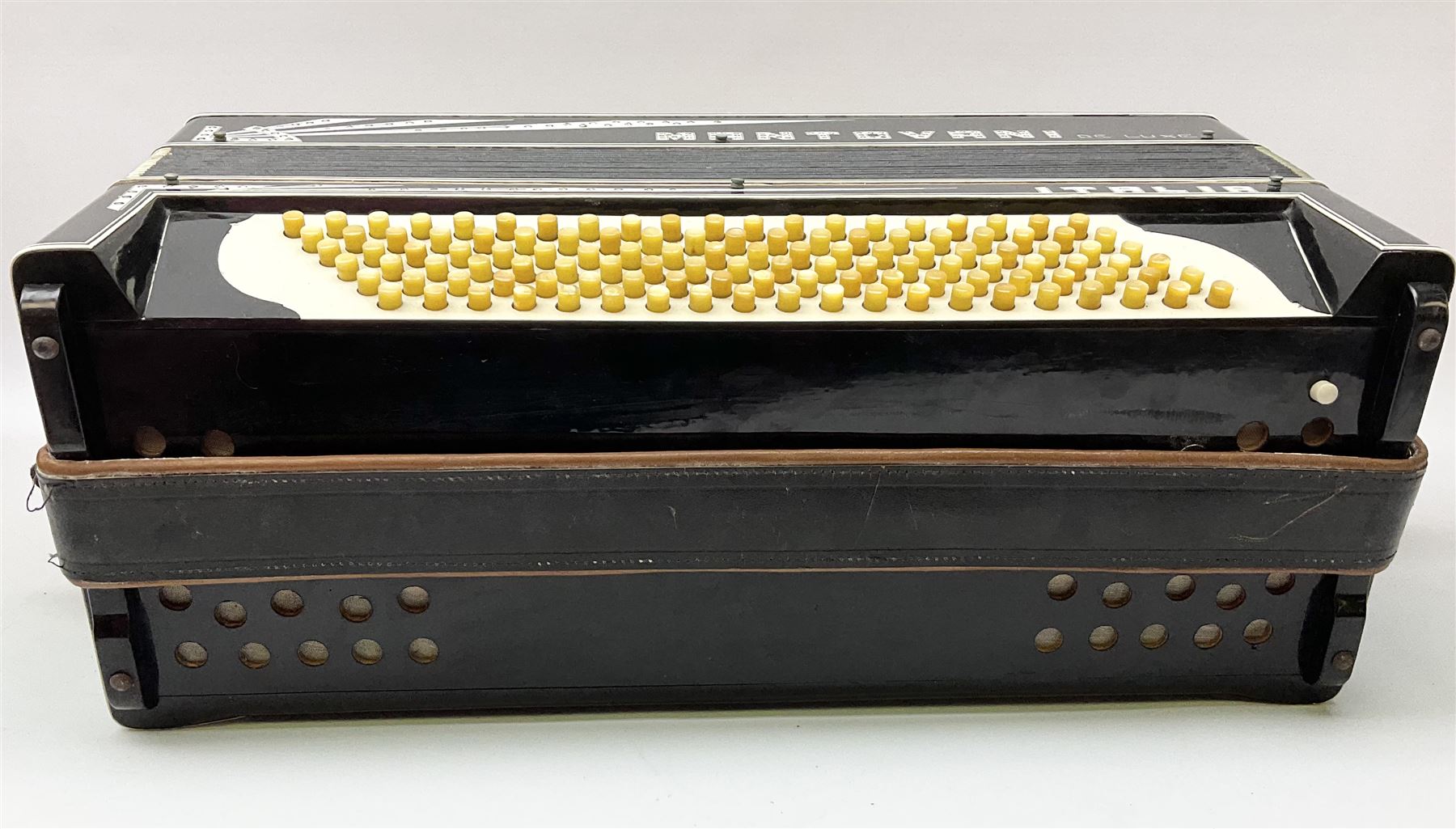 Italian Mantovani piano accordion with Art Deco style black and white case, twenty-four keys and one-hundred and twenty buttons L52cm in carrying case