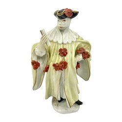  18th century Meissen figure of a Avvocato or the Lawyer from the Commedia Dell'arte series, circa 1740-45, modelled by J J Kandler, wearing gilt edged black tricorn hat, white mask, and yellow cape adorned with red rosettes, holding a scroll in his right hand, upon shaped oval base, no visible mark, H14.5cm