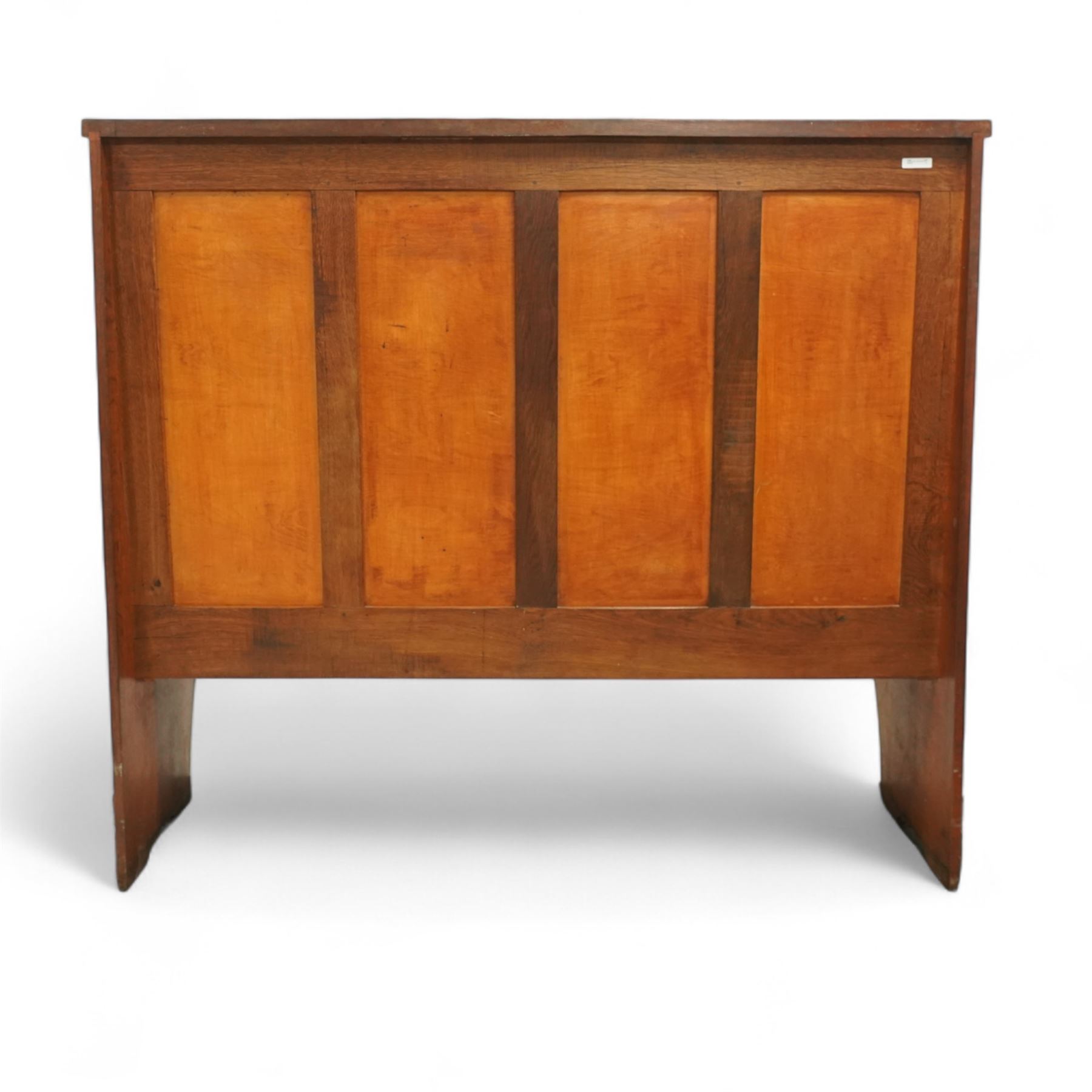 Sid Pollard of Thirsk – late 20th century adzed oak settle, tall panelled back with projecting top rail, shaped arms and tan upholstered drop-in seat, raised on chamfered end supports
