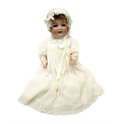 Simon and Halbig bisque head doll with applied hair, sleeping eyes, open mouth with teeth and trembly tongue and composition body with jointed limbs, marked 'Simon & Halbiig 126 Germany 50' H56cm