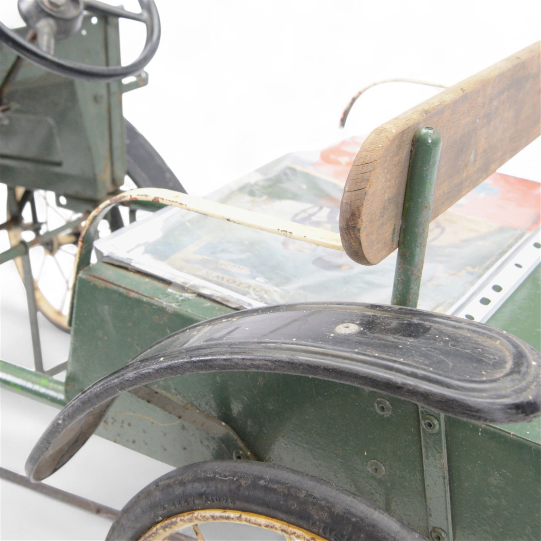Triang child's pedal car in the style of a vintage automotive, likely a De Dion Bouton or an early Renault, painted in dark green with pale yellow details, H52cm