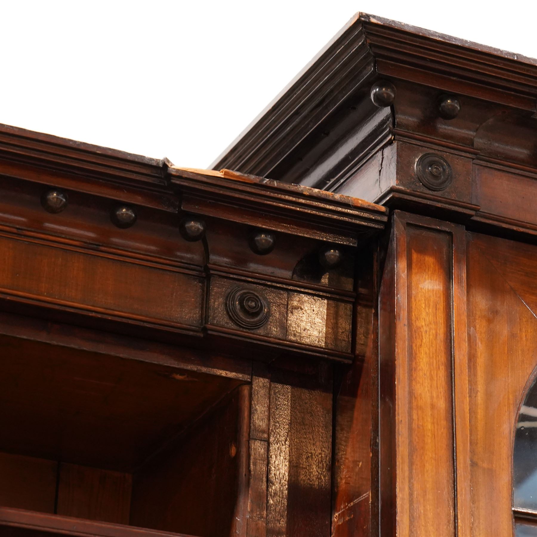 Large Georgian mahogany library bookcase, projecting moulded cornice with row of globular mounts, adjustable shelving enclosed by six astragal glazed doors, fitted with two slides and six panelled cupboard doors, two banks of five drawers, on moulded plinth base; together with two pairs of associated astragal glazed doors in mahogany, from the same property (W55.5cm x H168cm & W48cm x 168cm)
