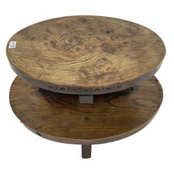 20th century figured elm occasional table, two oval tiers raised on cruciform base, the top tier carved with incised decoration 