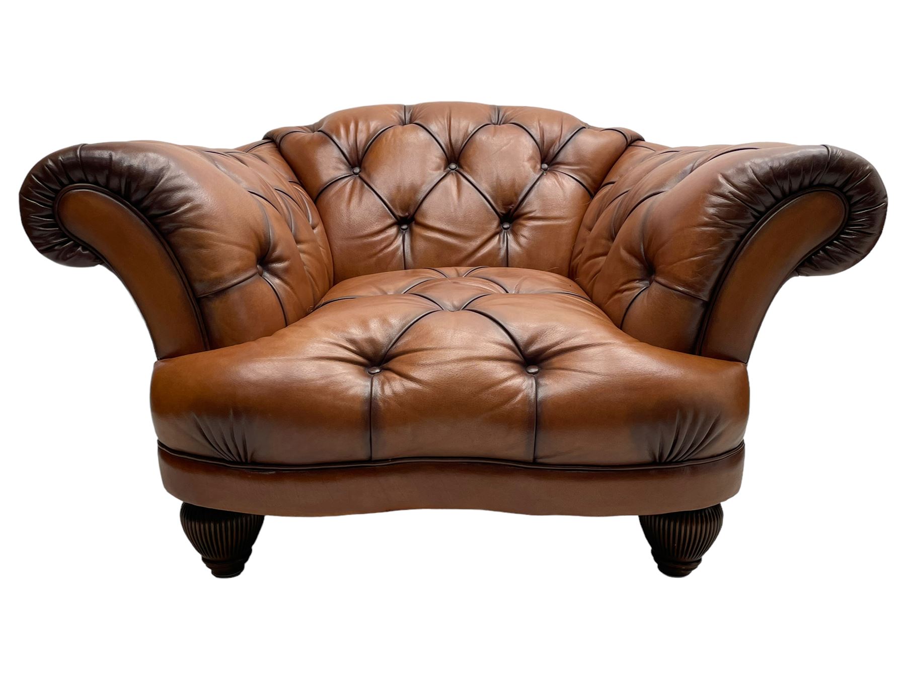 Tetrad - 'Oskar' armchair, Chesterfield shape with rolled arms, upholstered in buttoned tan leather, on turned and reed moulded feet 